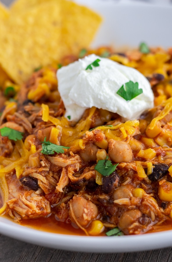 Chicken Taco Chili made in the Instant Pot or Crock Pot. Tender pieces of shredded chicken with corn, black beans, garbanzo beans, in a tomato base sauce.